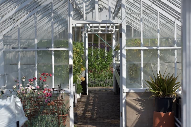 Close-up of a white aluminum greenhouse with polycarbonate panels